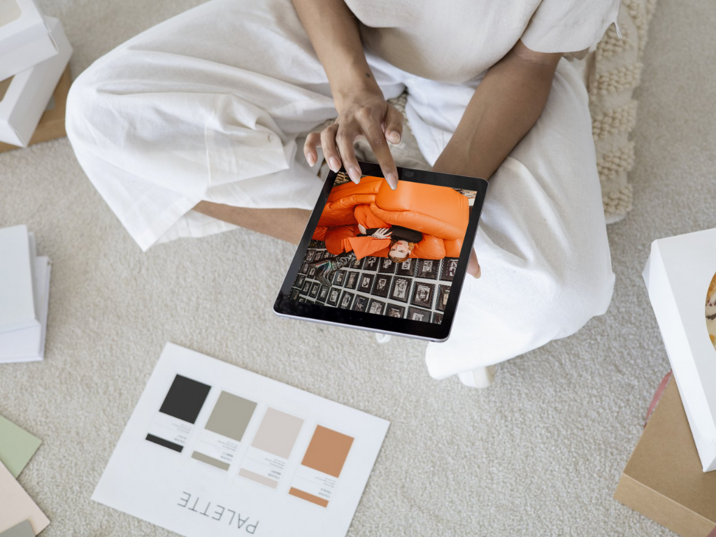 woman sitting on the floor with an ipad and color swatches